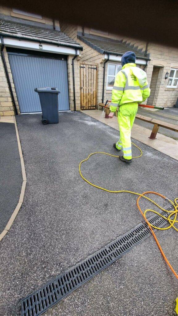 Spraying biocide on washed tarmac driveway in Bradford