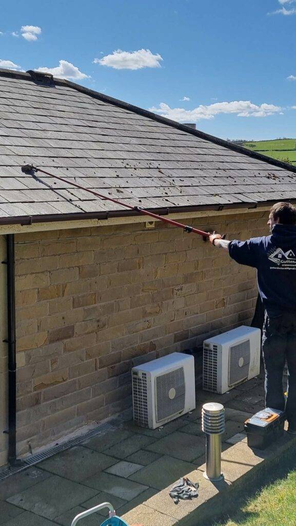 Roof moss removal from delicate slate tiles using pole and blade in Halifax