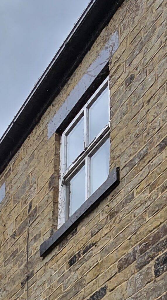 close-up of ivy tendrils left on a brick wall after ivy has been cut back