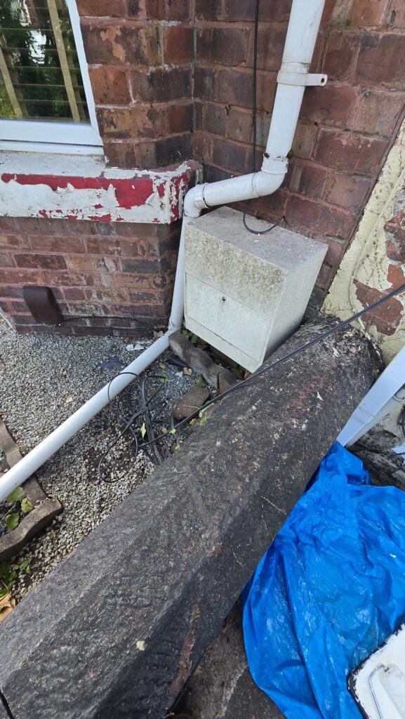 Front garden wall and lower property frontage before cleaning and exterior improvements following ivy removal.