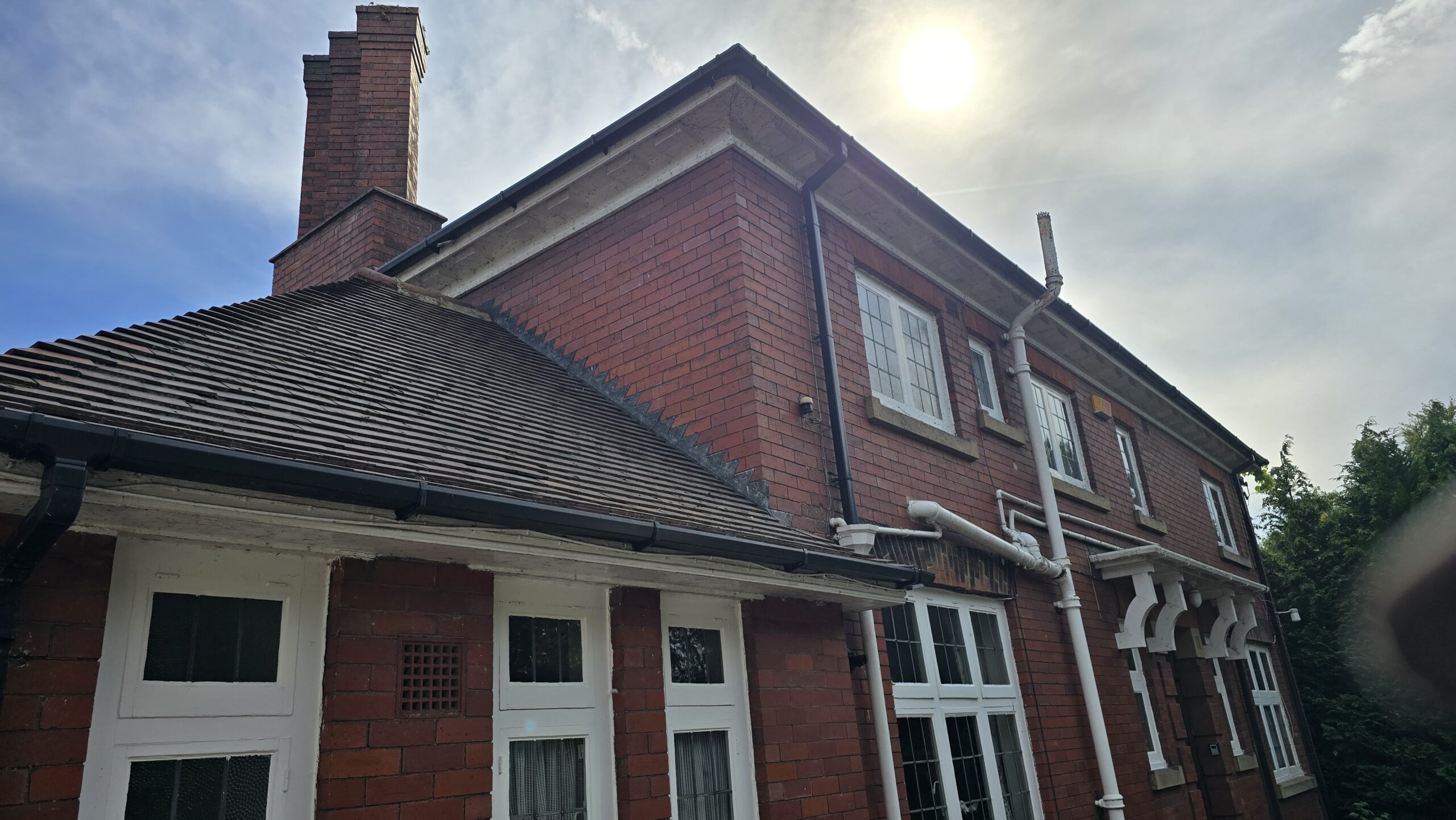 Brick wall and roofline in Ackworth after the ivy was removed