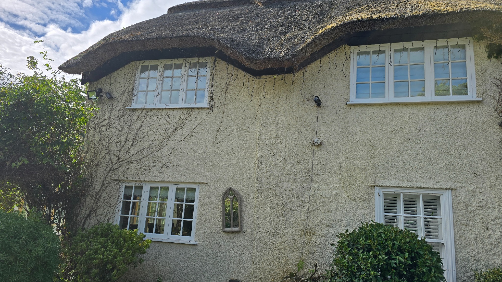 Thatched cottage in Neston after professional ivy removal by Trusted Cleanerz